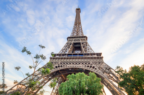 Beautiful Eiffel tower in summer Paris, France under the blue sky white cloud, Eiffel Tower, the most romantic tourist attraction and the symbol of Paris.