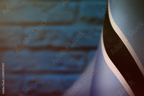 Botswana flag for honour of veterans day or memorial day. Glory to the Botswana heroes of war concept on blue blurred painted brick wall background.
