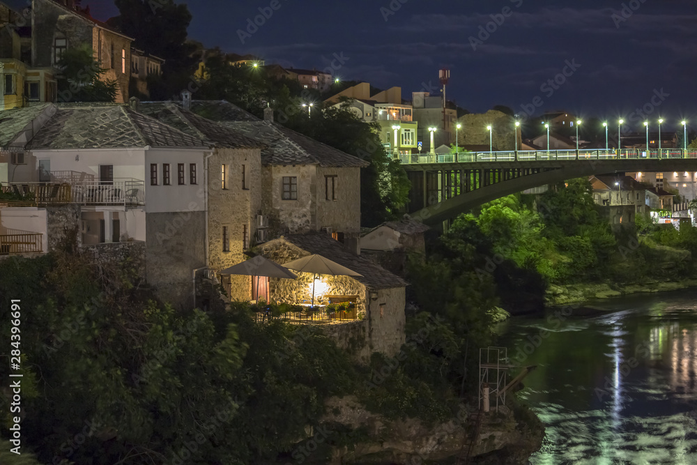 Mostar, Bosnia and Herzegovina at night . The Old Bridge, Stari Most, with emerald river Neretva.