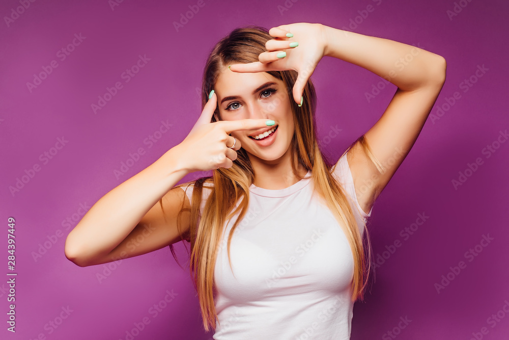 Studio portrait of beautiful young and gorgeous woman turns her finger. Photography concept. Studio portrait of beautiful young and gorgeous woman turns her finger. Photography concept.