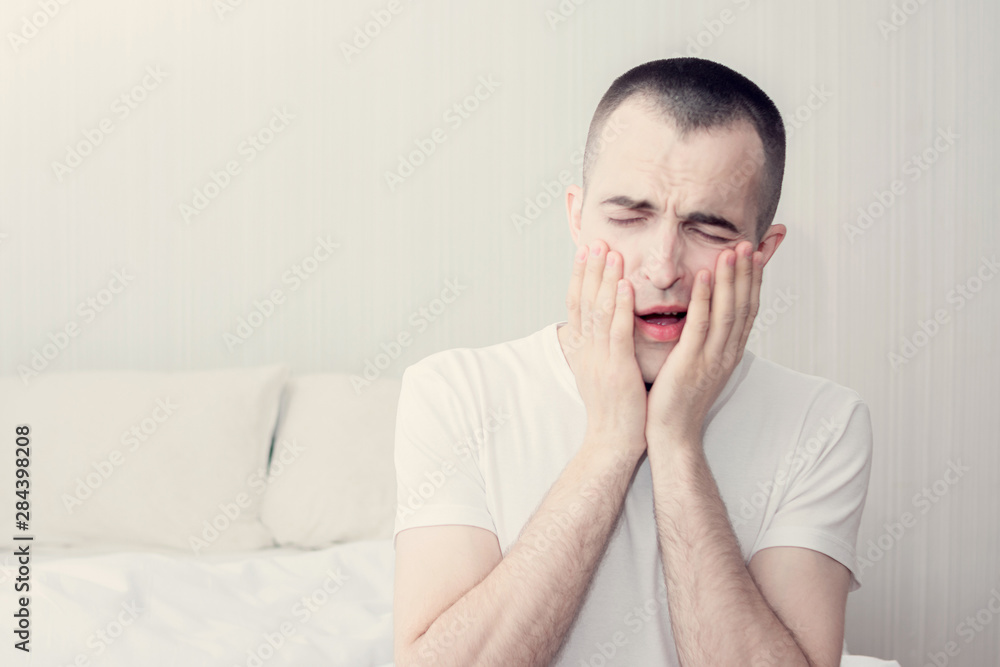 Young man woke up early in the morning, sleepy man yawning, portrait, toned Young man woke up early in the morning, sleepy man yawning, portrait, toned