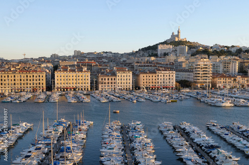 France, Provence-Alpes-Cote d'Azur, Bouches-du-Rhone, Marseille. Vieux-Port with Basilique Notre Dame de la Garde on the hill in the background