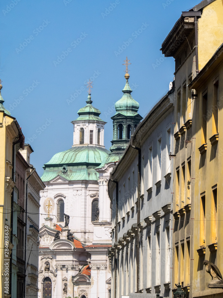 Czech Republic, Prague. St Nicholas Church dome above orange roof tops of Mala Strana.