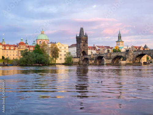 Czech Republic, Prague. View of the Lesser town bridge tower and clock tower on the Vltava river. © Julie Eggers/Danita Delimont