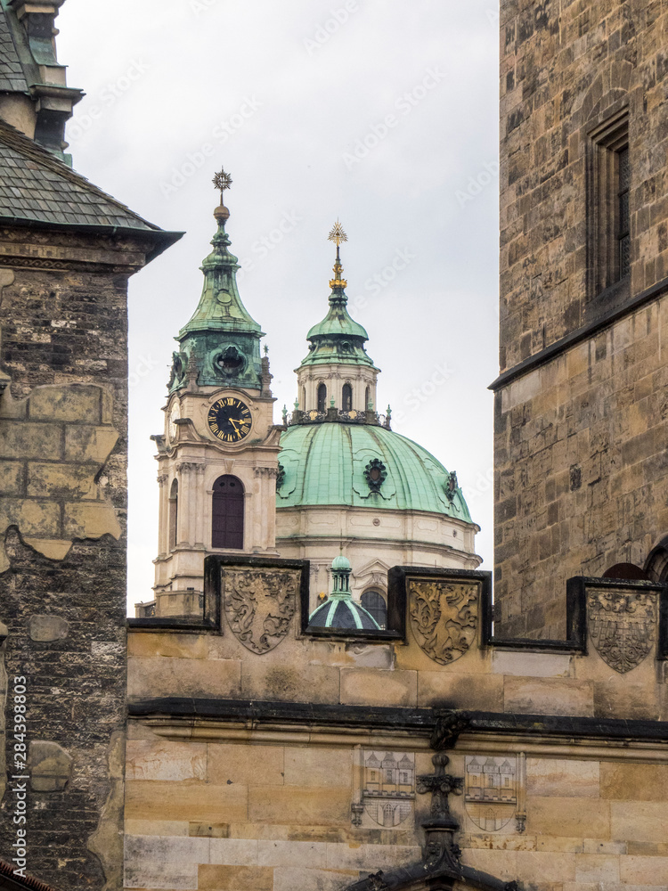 Obraz premium Czech Republic, Prague. St Nicholas Church dome above orange roof tops of Mala Strana.