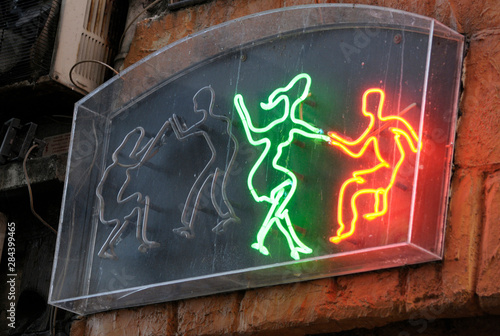 France, Paris. Neon dancers at the Caveau de la Huchette Jazz Club