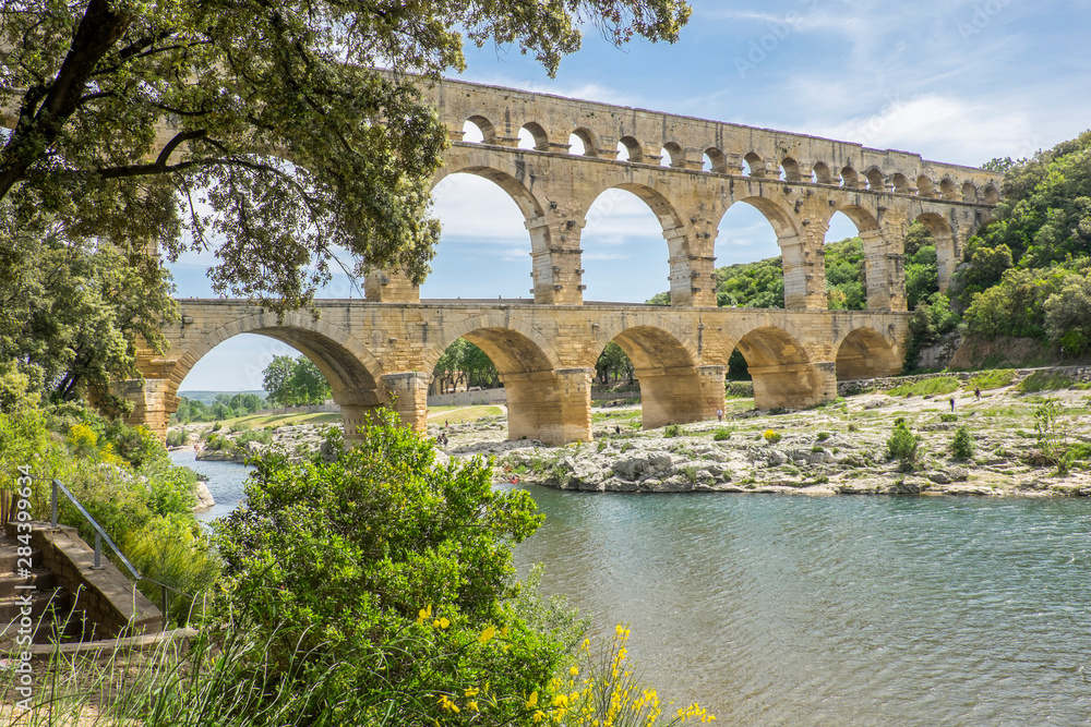 France, Nimes, the Pont du Gard is an ancient Roman aqueduct bridge that crosses the Gardon River. It is made of limestone between 40-60 AD.