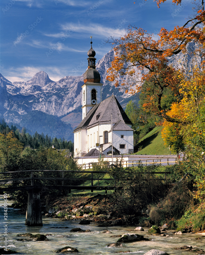Germany, Bavaria, Ramsau. The Ramsauer Ache flows by the church, or Kunterwegkirche, at Ramsau in Bavaria, Germany.