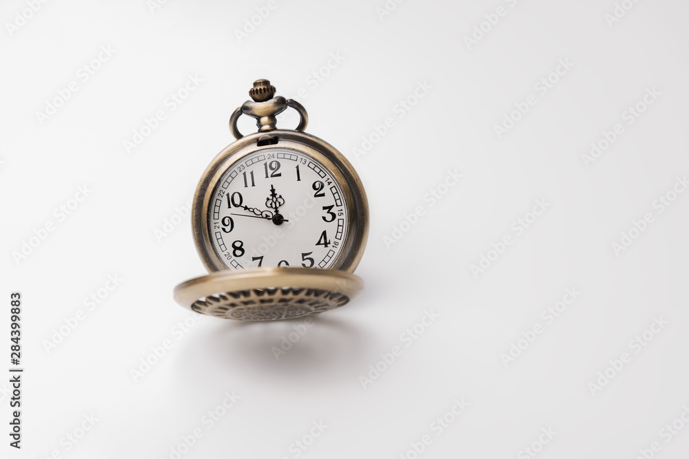 Old pocket watch closeup isolated on white background