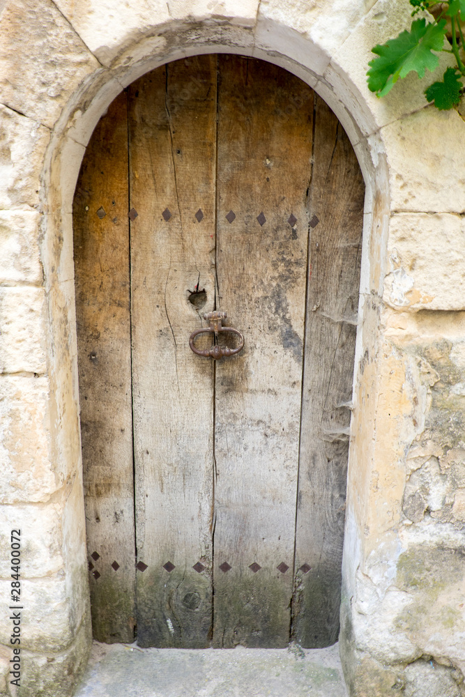 France, Provence, Luberon, Menerbes. Wooden door to vacated home. France, Provence, Luberon, Menerbes. Wooden door to vacated home.