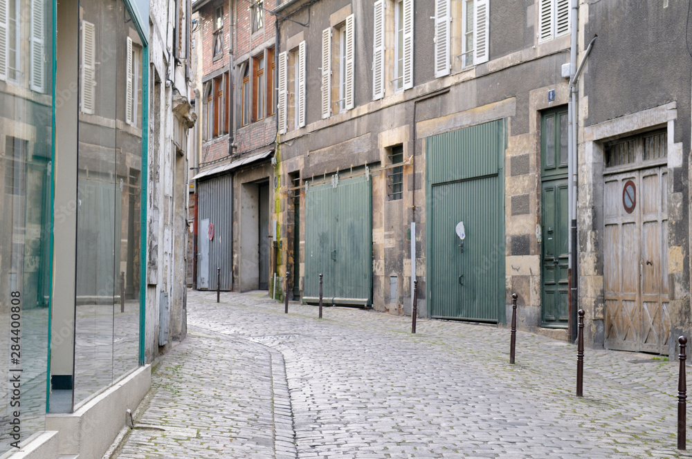 Fototapeta premium France, Burgundy, Nievre, Nevers. Narrow street with closed stores