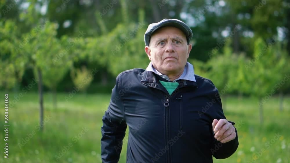 60s Senior Man Having Difficulty Jogging Outdoors - Unhealthy Elderly Man Doing Sports 60s Senior Man Having Difficulty Jogging Outdoors - Unhealthy Elderly Man Doing Sports