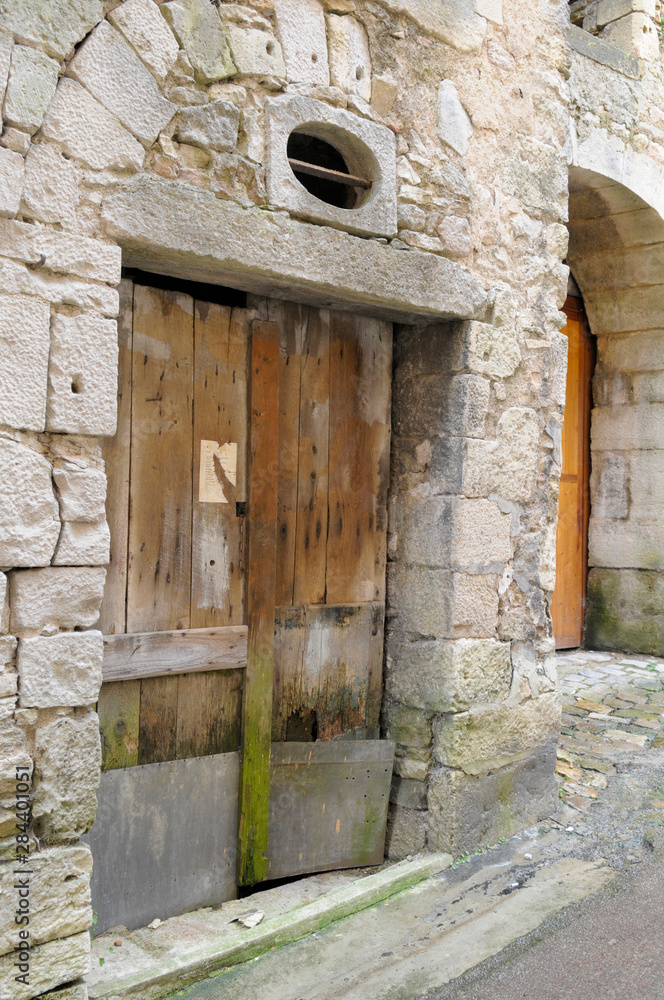 France, Burgundy, Nievre, Clamecy. Old doors in a stone building
