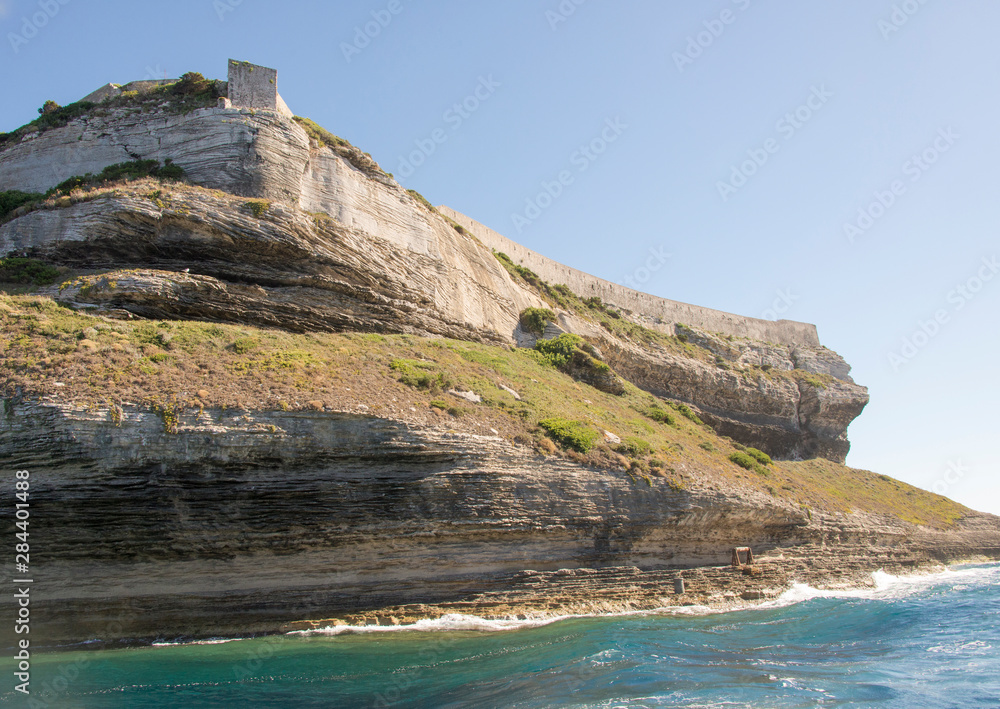 France, Corsica, Bonifacio. Dramatic cliffs of port entrance with fortress wall