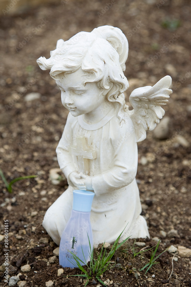 Ireland, County Mayo, Murrisk. Angel and holy water at a grave site. Ireland, County Mayo, Murrisk. Angel and holy water at a grave site.