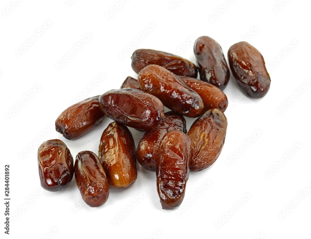 Dried dates over white background. Heap of dried dates isolated on white background. Dried dates over white background. Heap of dried dates isolated on white background.