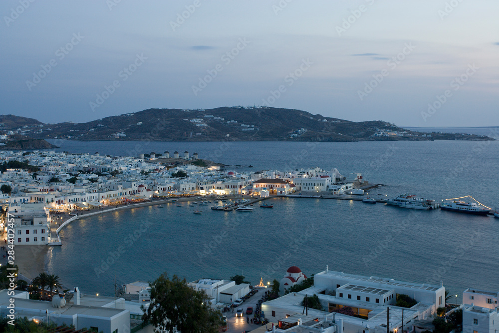 Greece, Mykonos, Hora. Evening view overlooking harbor.