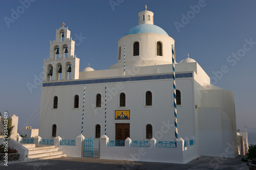 Greece, Santorini, Thira, Oia. Large Greek Orthodox church in main square with dome and bell tower.