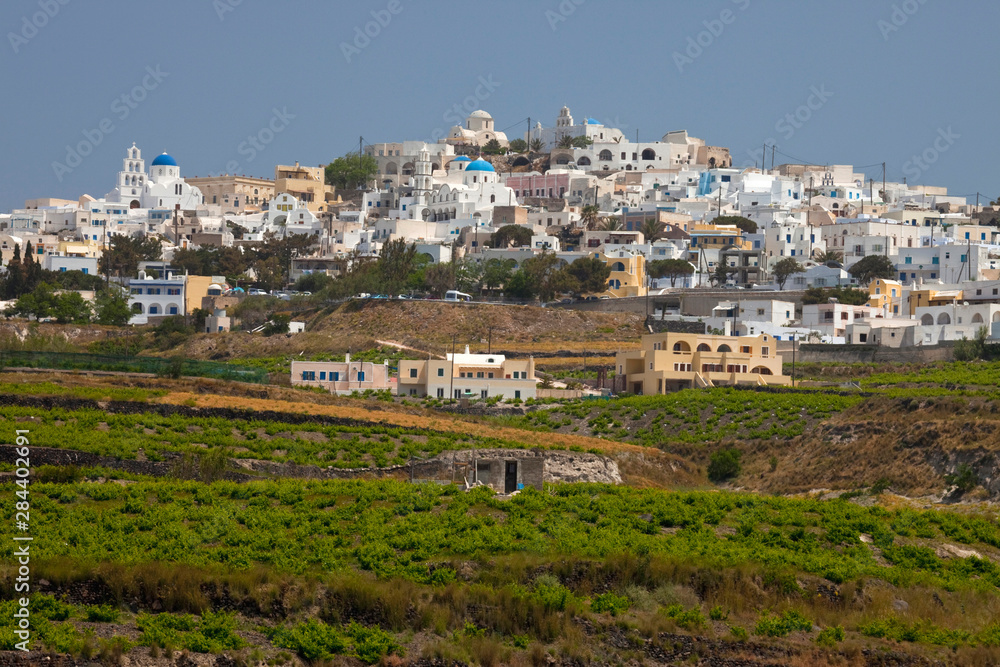 Greece, Santorini. Town of Pyrgos with vineyards surrounding the base