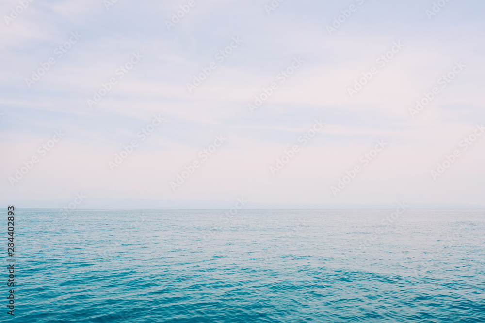 Blue sea and fair shiny sky background.