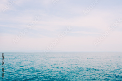 Blue sea and fair shiny sky background.