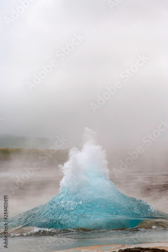 Iceland, Golden Circle, Strokkur Geyser. The Strokkur Geyser erupts with much steam.