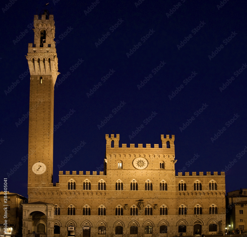 Italy, Tuscany, Sienna. Torre del Mangia in the Piazza del Campo at dusk.