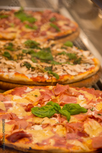 Italy, Tuscany, Florence. Traditional Italian pizza with prosciutto fresh herbs..
