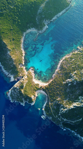Aerial drone photo of iconic paradise bay of Porto Timoni with tropical deep blue and turquoise clear sea, Corfu island, Ionian, Greece © aerial-drone