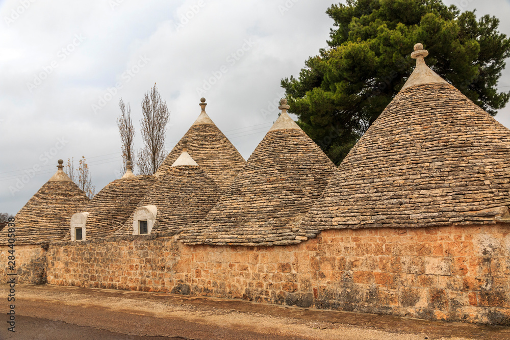 Italy, Apulia, Bari, Itria Valley, Alberobello. A trullo house is a Apulian dry stone hut with a conical roof. UNESCO Heritage Site. Italy, Apulia, Bari, Itria Valley, Alberobello. A trullo house is a Apulian dry stone hut with a conical roof. UNESCO Heritage Site.