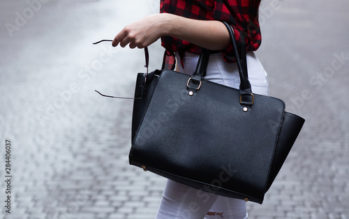 Woman holding black leather bag photo