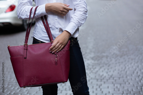Closeup shot of woman holding leather purse