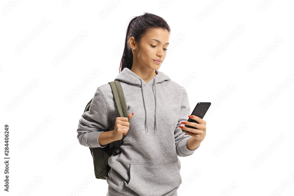 Teenage female student holding a mobile phone and looking at it Teenage female student holding a mobile phone and looking at it