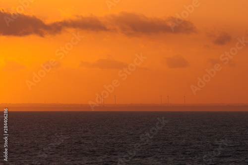 Wind turbines on italian coast at sunset © Gianluca