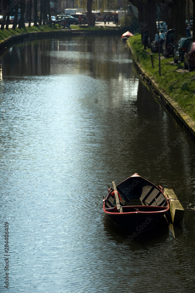 The Netherlands (aka Holland). Medieval cheese producing town of Edam. Edam canal with rowboat.