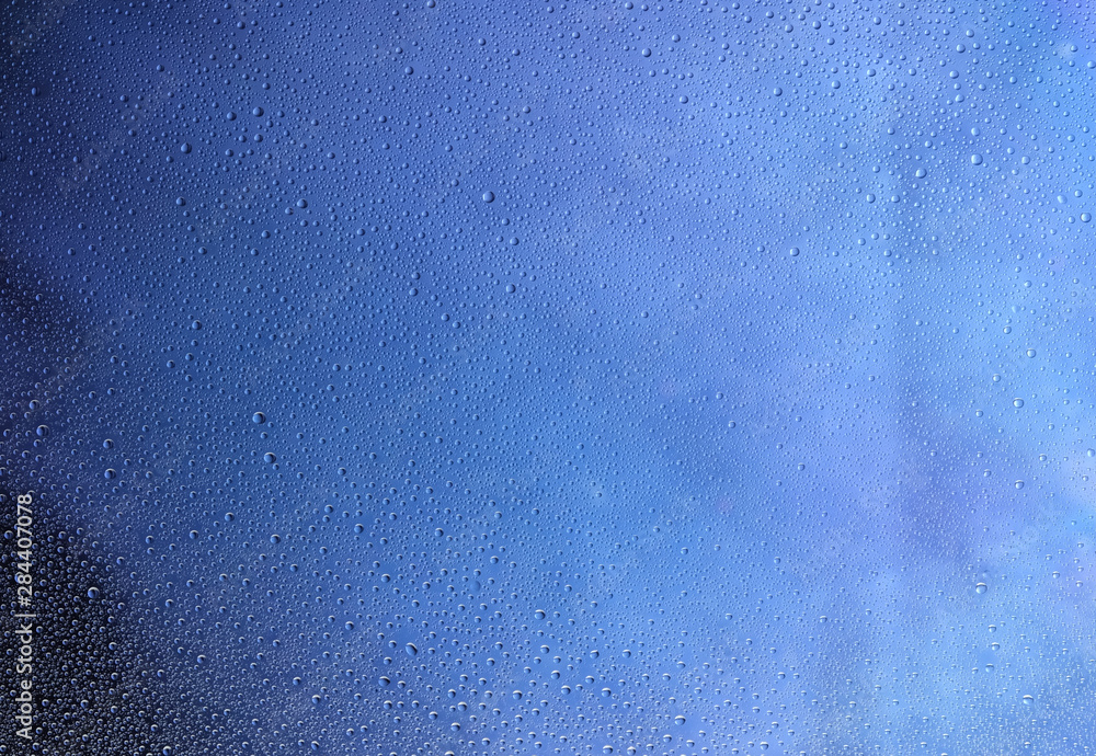 drops of water on glass on a blue background