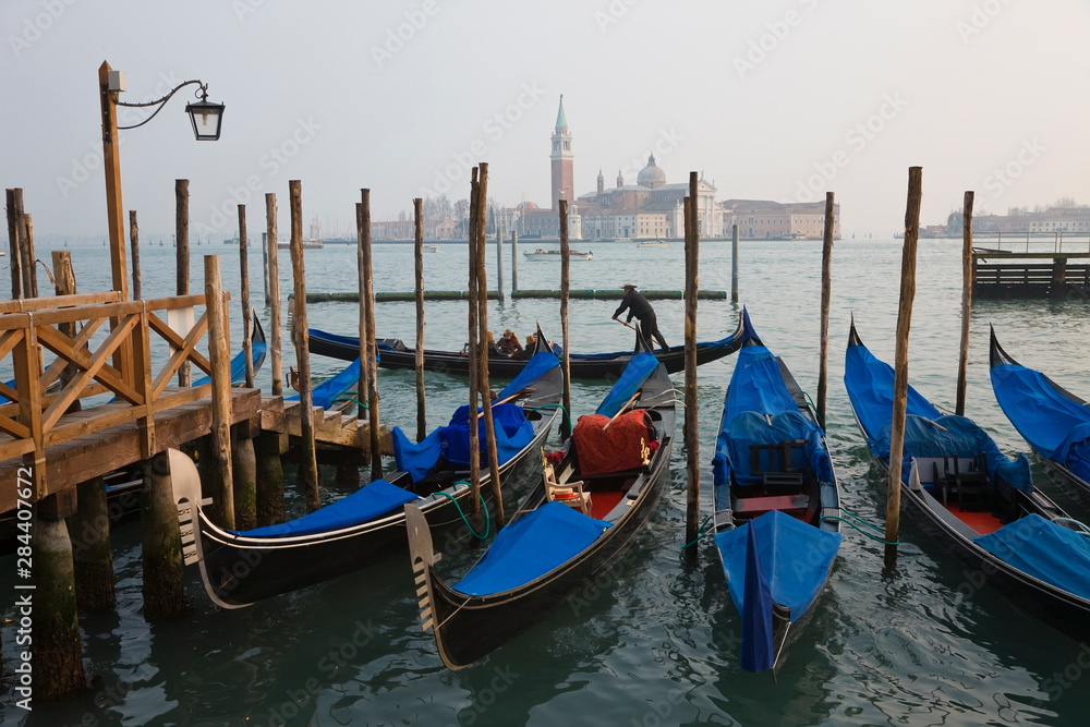 Italy, Veneto, Venice, view of Gondolas from Piazza San Marco, with San Giorgio Maggiore in the background