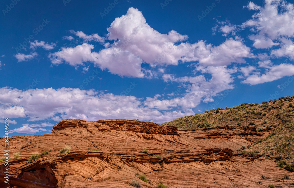 Arid landscape of Arizona. The crumbling sandstone mountains and blue sky