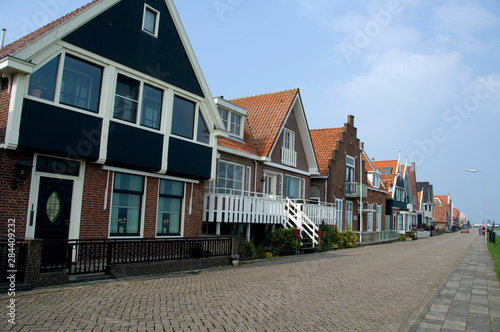Fototapeta Naklejka Na Ścianę i Meble -  The Netherlands (aka Holland), Volendam. Popular picturesque fishing village on the IJsselmeer. Typical homes along dike.