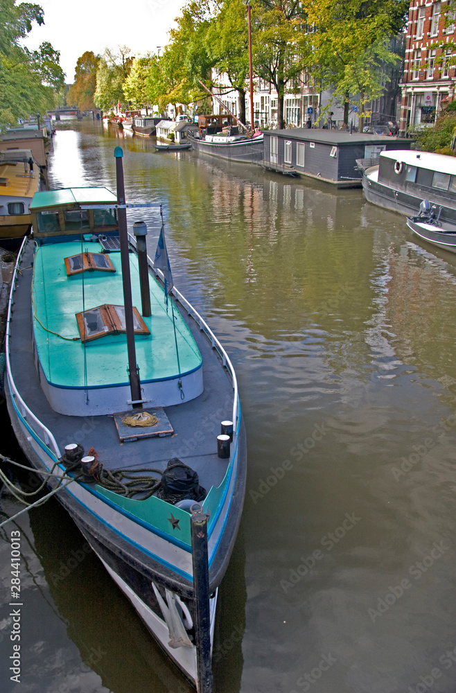 Colorful houseboats line an Amsterdam canal