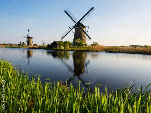 Netherlands, Kinderdijk, Windmills with evening light along the canals of Kinderdijk