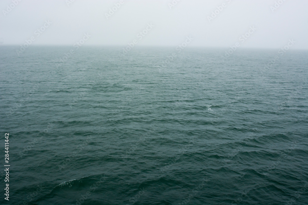 Norway. Svalbard. Hornsund. Heavy clouds over the calm water. Norway. Svalbard. Hornsund. Heavy clouds over the calm water.