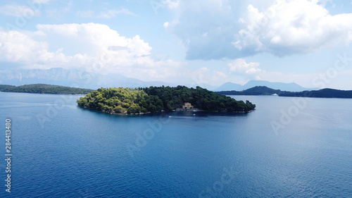 Aerial drone photo of iconic uninhabited island of Madouri in bay of Nydri and Mansion of 19th-century poet Aristotelis Valaoritis, Lefkada, Ionian, Greece