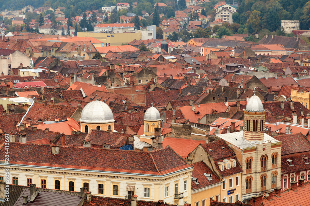Romania. Brasov. Rooftops and city from hilltop.
