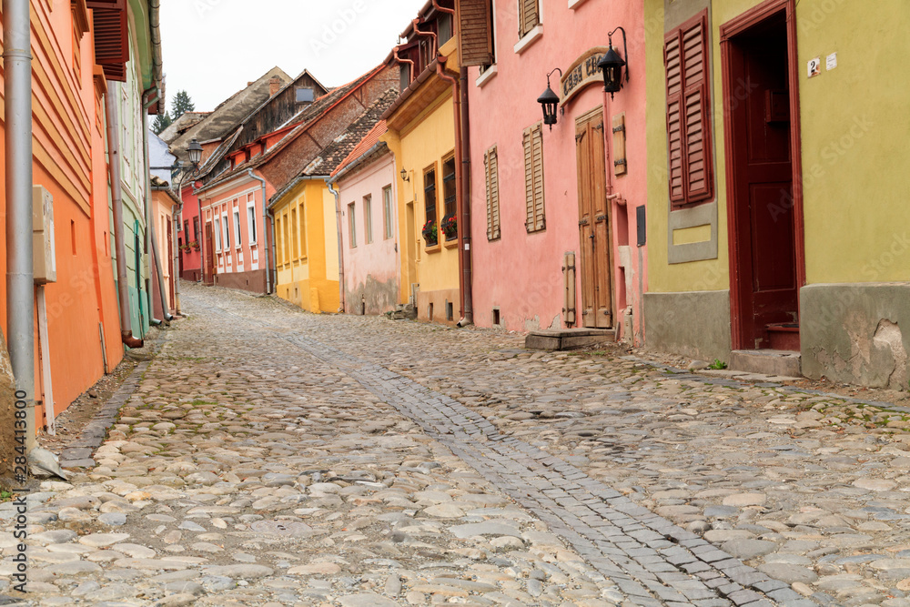 Romania. Mures County, Sighisoara. Cobbled street.