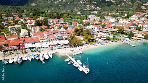 Fototapeta Naklejka Na Ścianę i Meble -  Aerial drone bird's eye view photo of iconic port of Nidri or Nydri a safe harbor for sail boats and famous for trips to Meganisi, Skorpios and other Ionian islands, Leflkada island, Ionian, Greece