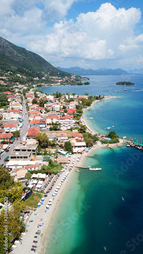 Fototapeta Naklejka Na Ścianę i Meble -  Aerial drone bird's eye view photo of iconic port of Nidri or Nydri a safe harbor for sail boats and famous for trips to Meganisi, Skorpios and other Ionian islands, Leflkada island, Ionian, Greece