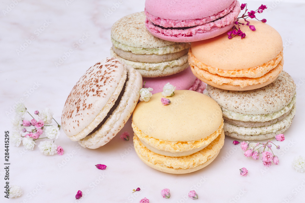 Few colored macarons on a white background