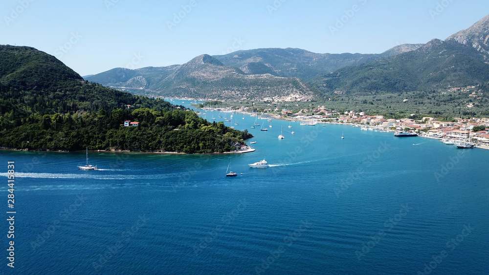 Aerial drone bird's eye view photo of iconic port of Nidry or Nydri a safe harbor for sail boats and famous for trips to Meganisi, Skorpios and other Ionian islands, Leflkada island, Ionian, Greece