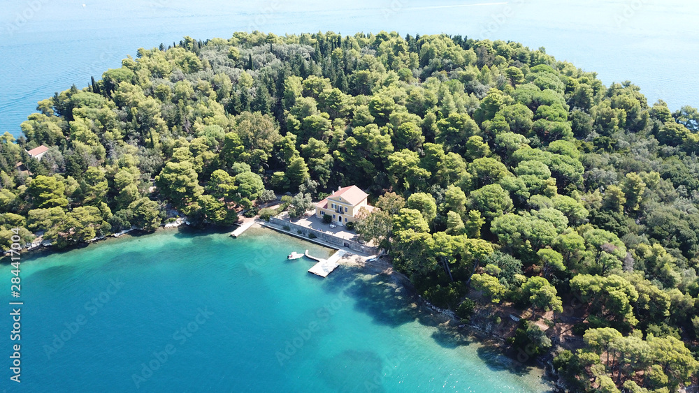 Aerial drone photo of iconic uninhabited island of Madouri in bay of Nydri and Mansion of 19th-century poet Aristotelis Valaoritis, Lefkada, Ionian, Greece